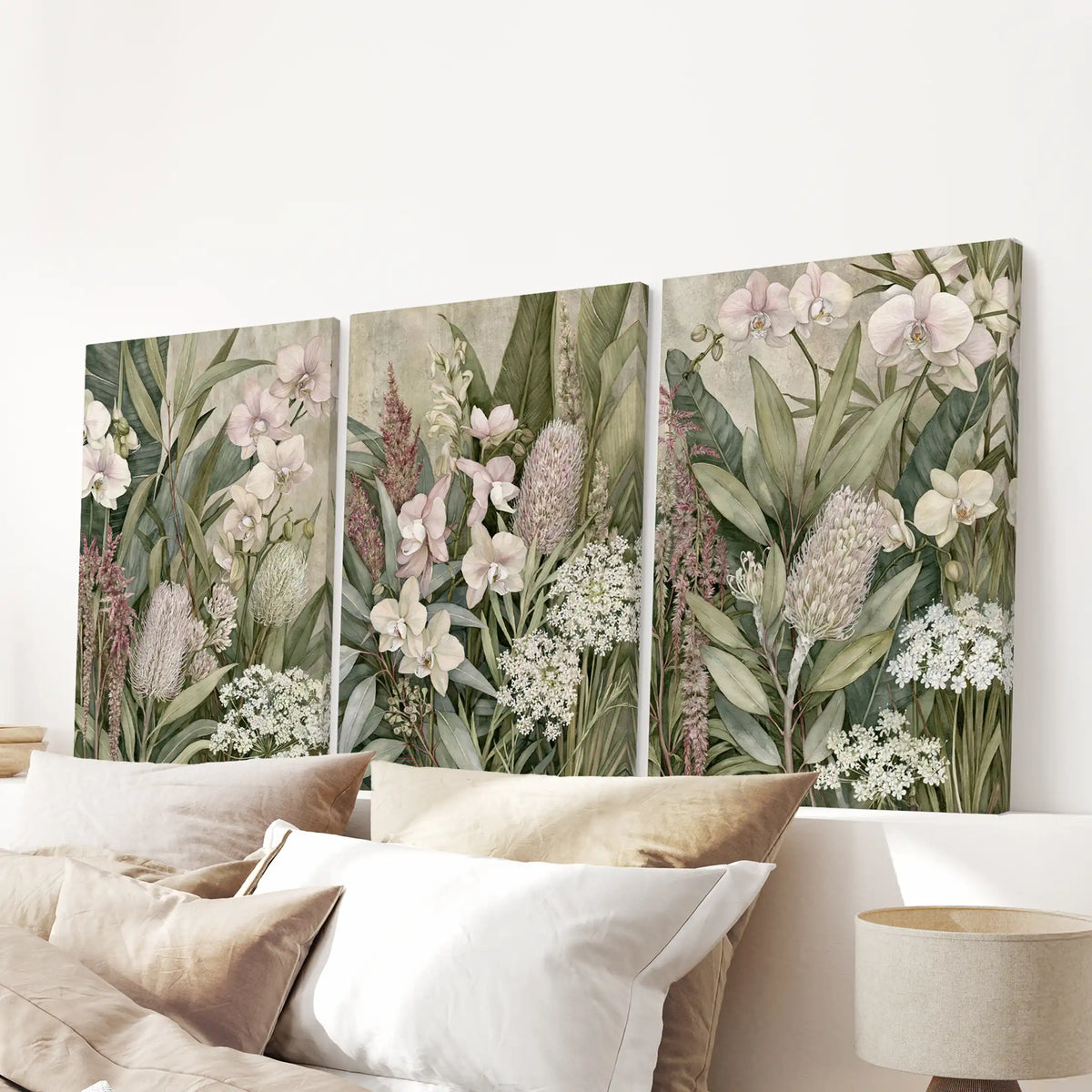 Tropical flowers and layered leaves fill three canvases above a bed.