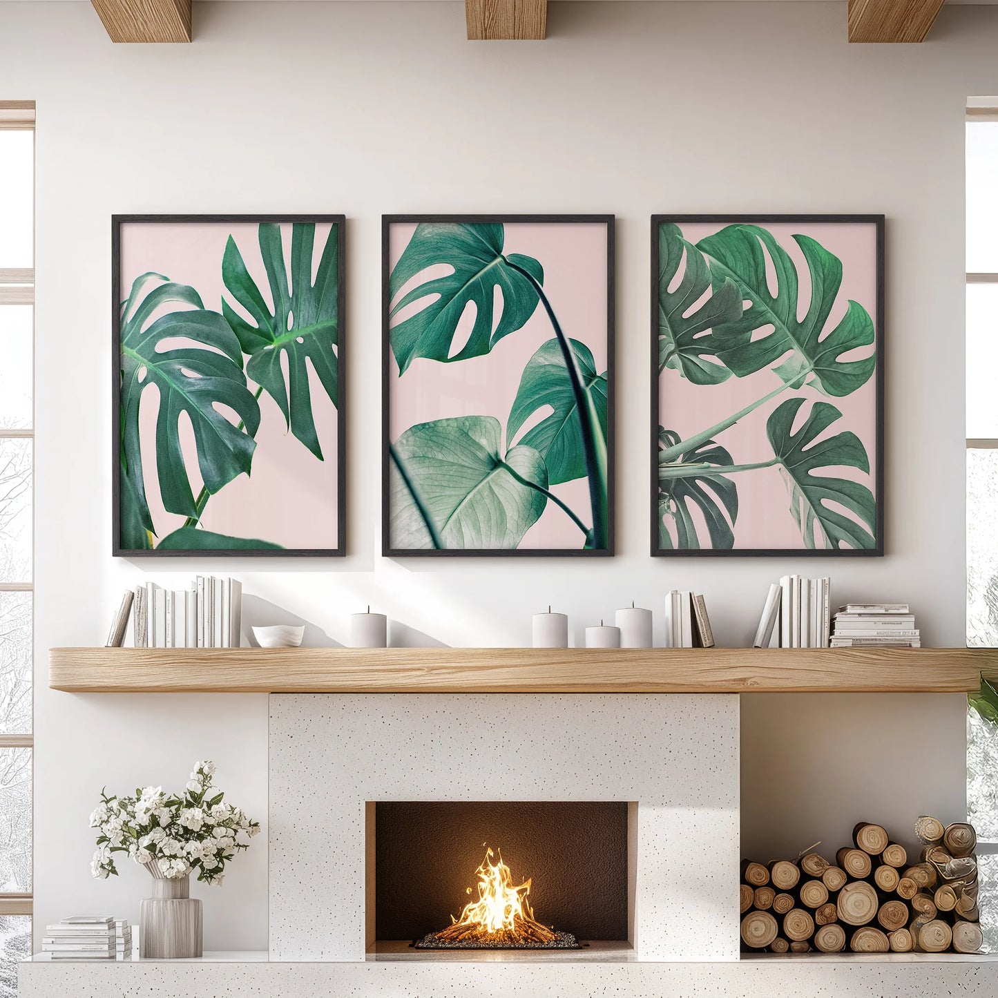 A trio of black-framed posters featuring pink monstera leaves forms striking wall art above the living room mantel, lending a lush, modern tone.
