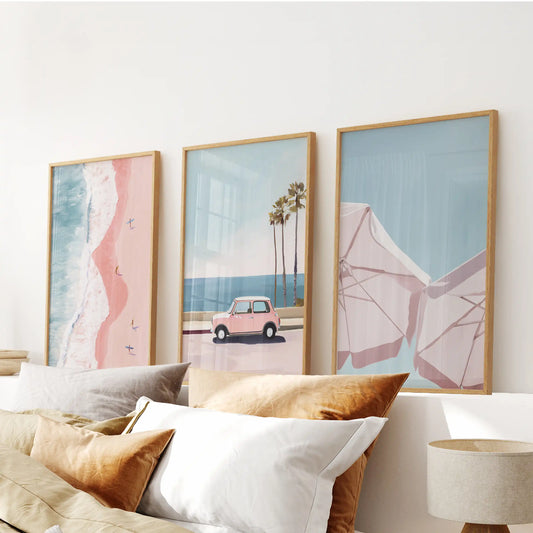 Light wood-framed artwork in three coastal panels pours subtle ocean hues over the headboard to calm the bedroom.