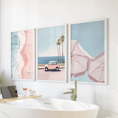 A trio of palm tree wall prints in white frames hangs above the bathtub, giving the bathroom a calm, breezy coastal feel.