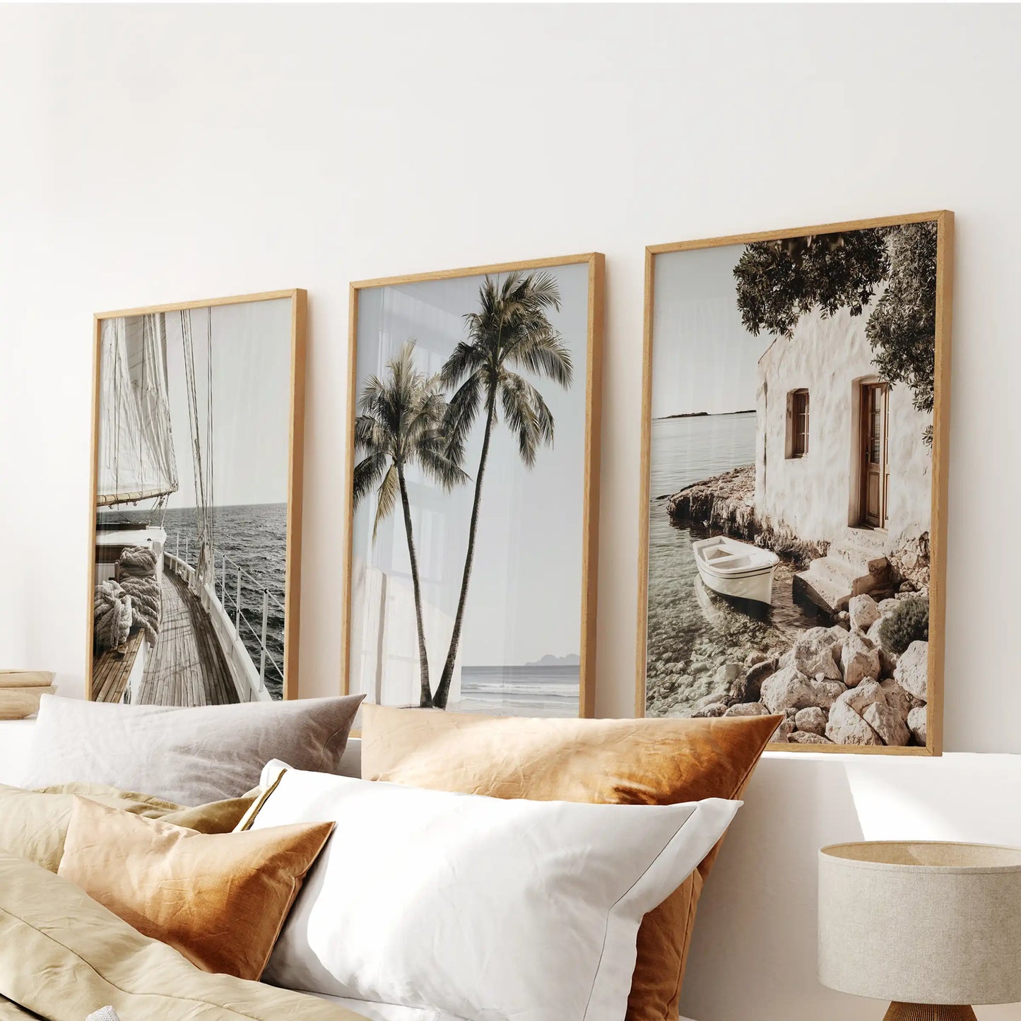 Beach house seascapes, a 3-print wood-framed collection, crowns the bedroom over the bed with soft horizon lines and coastal light.