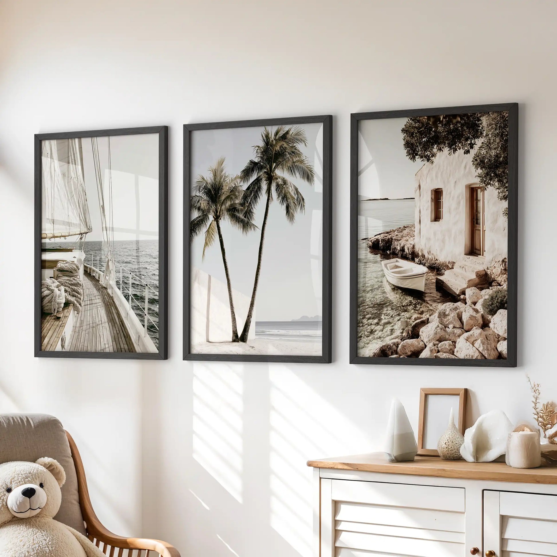 Ocean shoreline wall art triptych in black frames brightens the kids room, floating over the dresser with soft blues and sandy edges.