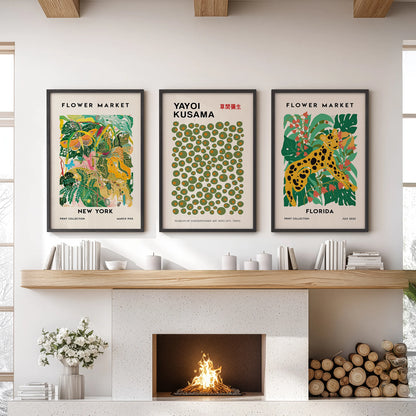 Green vintage botanical wall art, a three-print set, hangs in sleek black frames above the sitting room mantel to bring a collected, gallery feel.