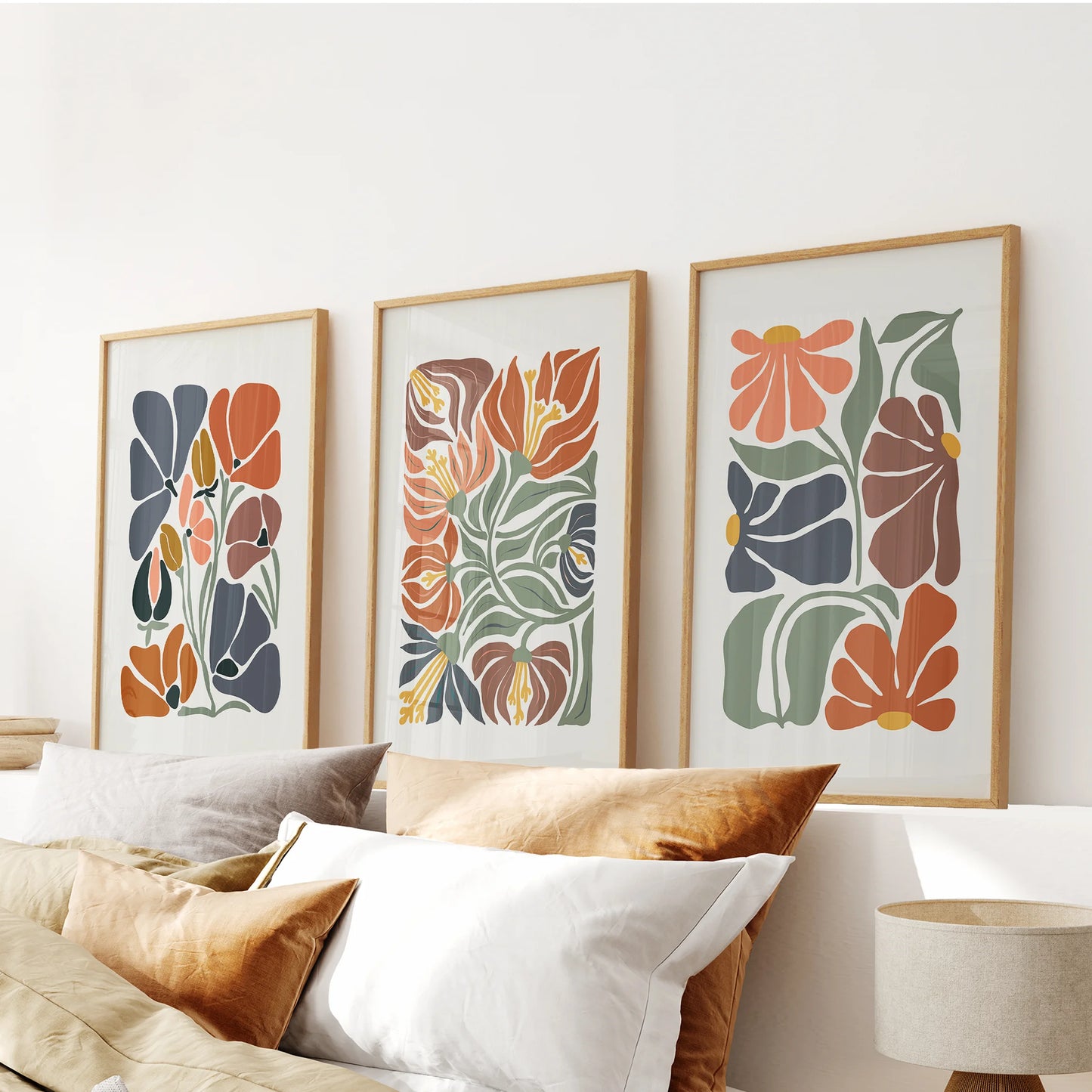 Y2K-style flower illustrations, a set of three in slim wood frames, style the bedroom above the headboard with nostalgic color and airy linework.