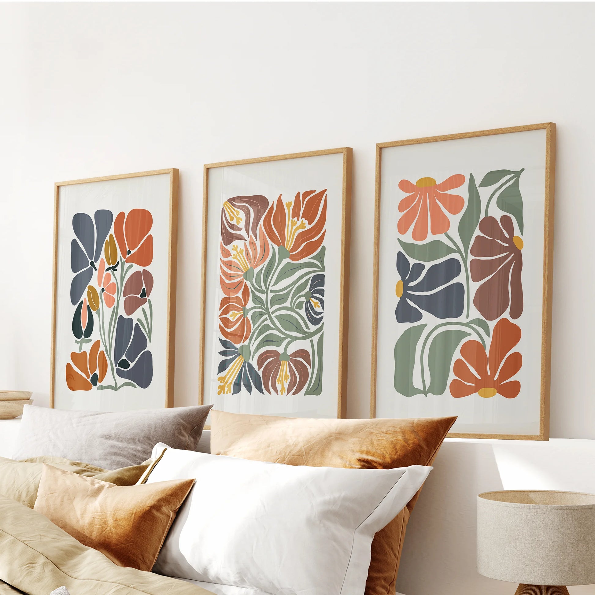 Y2K-style flower illustrations, a set of three in slim wood frames, style the bedroom above the headboard with nostalgic color and airy linework.