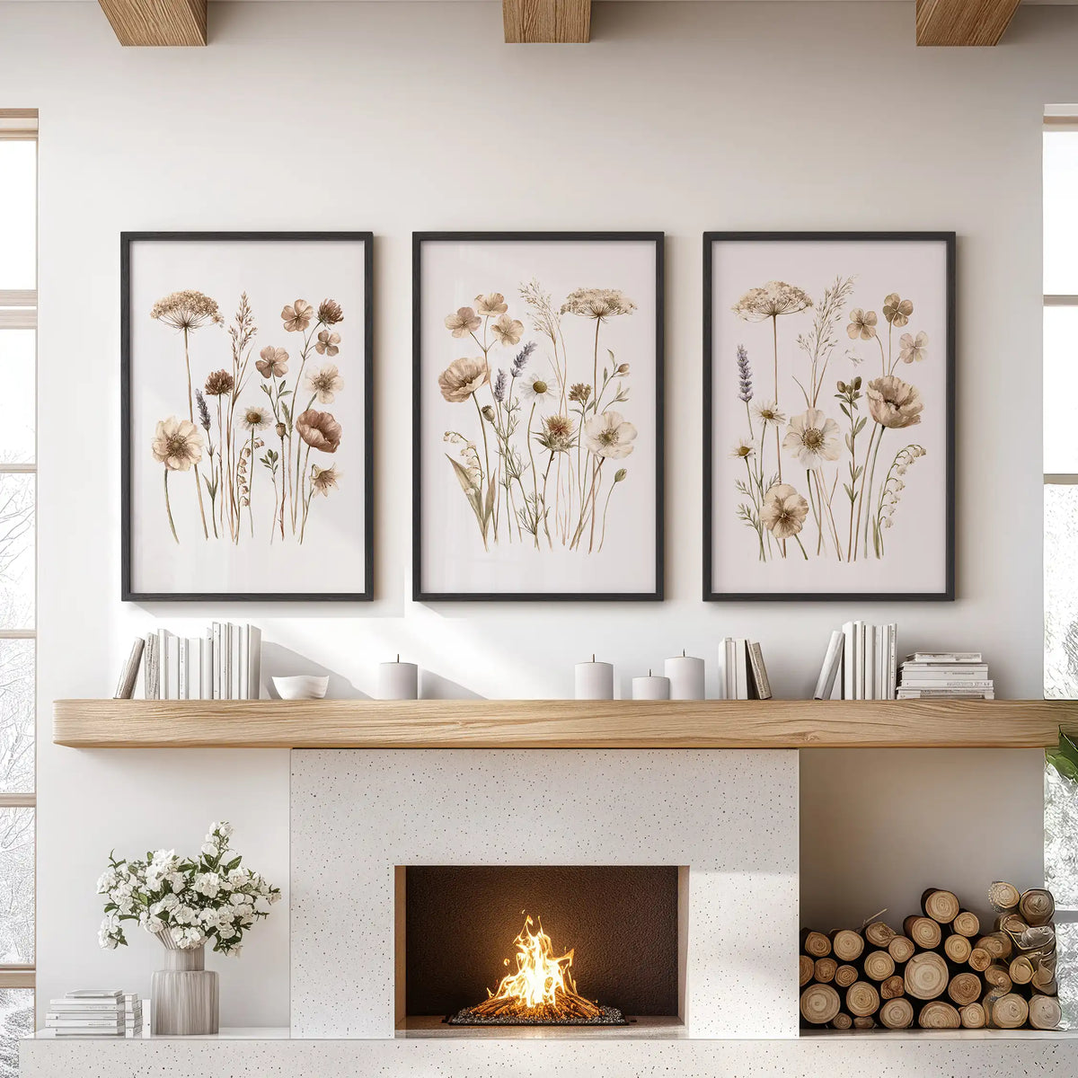 Neutral wildflower prints hang in three black frames above a fireplace.