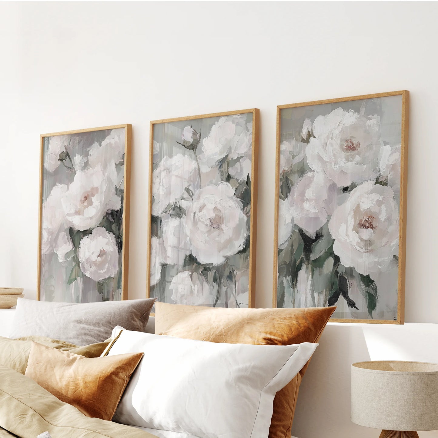 Summer garden blooms in a 3-print wall set, thin wood frames poised over the bedroom headboard for a fresh, airy floral statement.