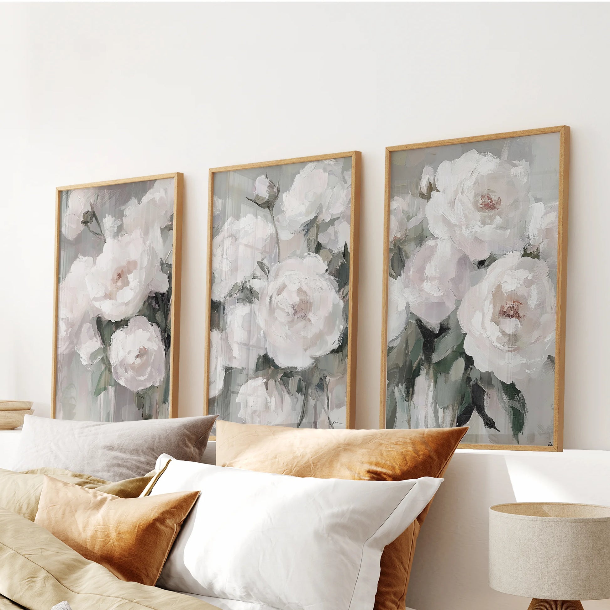 Summer garden blooms in a 3-print wall set, thin wood frames poised over the bedroom headboard for a fresh, airy floral statement.