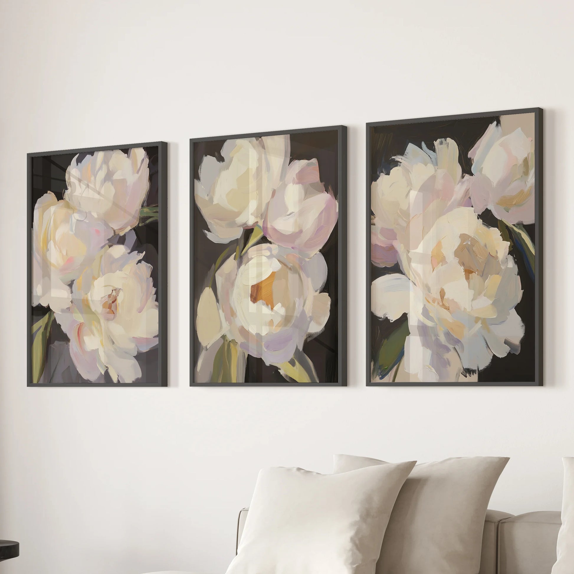 Victorian peony botanicals in a set of 3 wall art prints line up behind the living room couch in sleek black frames for polished, timeworn charm.