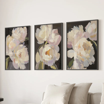Victorian peony botanicals in a set of 3 wall art prints line up behind the living room couch in sleek black frames for polished, timeworn charm.