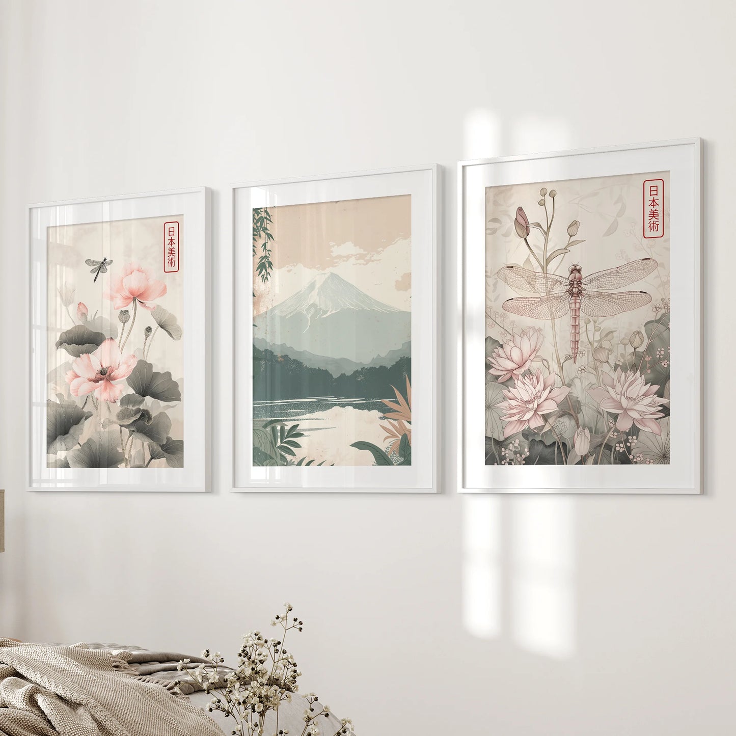 Three Japandi-style nature posters in white-matted frames hang beside the bed, giving the bedroom a measured, modern stillness.