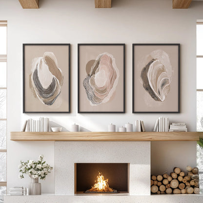 This trio of vintage oyster shell art prints in slim black frames anchors the family room mantel with a calm coastal touch.