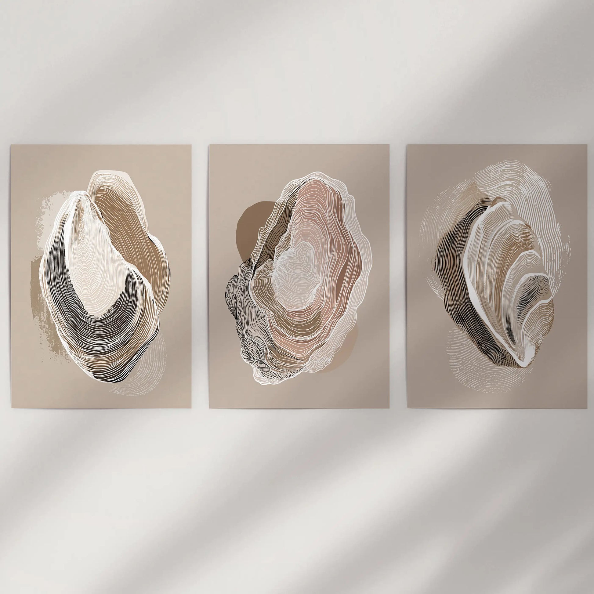 Three beige oyster art prints appear rolled and unframed, ready for a simple wall that favors understated coastal ease.