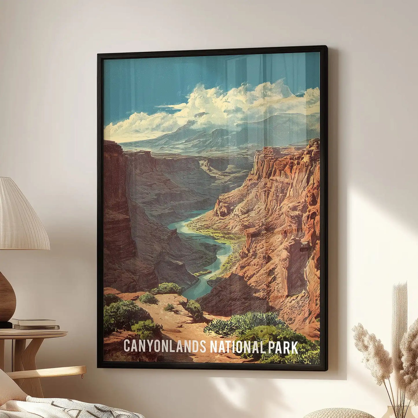 Framed canyon landscape wall art in black anchors the sitting room above a lounge chair, its blue-brown view echoing Canyonlands’ curves.