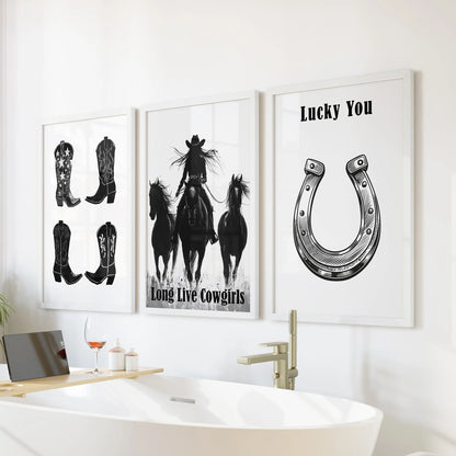 Three cowgirl boot illustrations in bright white frames stack above the tub, turning the bathroom wall into a light Western gallery.