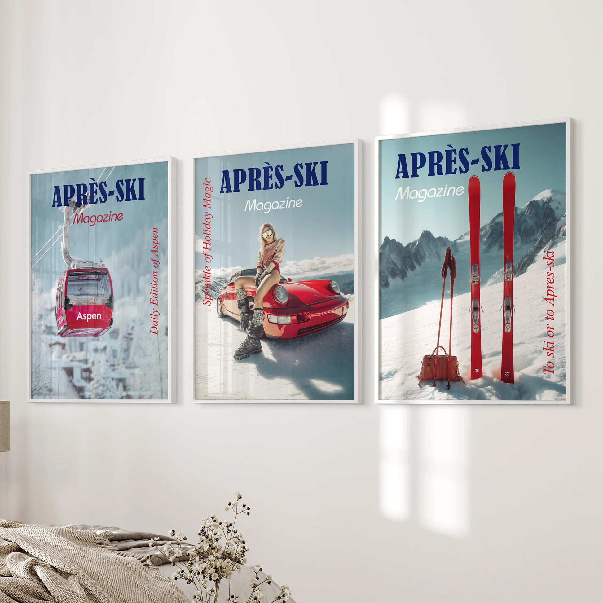 Apres-ski magazine covers as a poster set of three, white framed, lend vintage wall art to the bedroom beside the bed with bold type and rosy snowscapes.