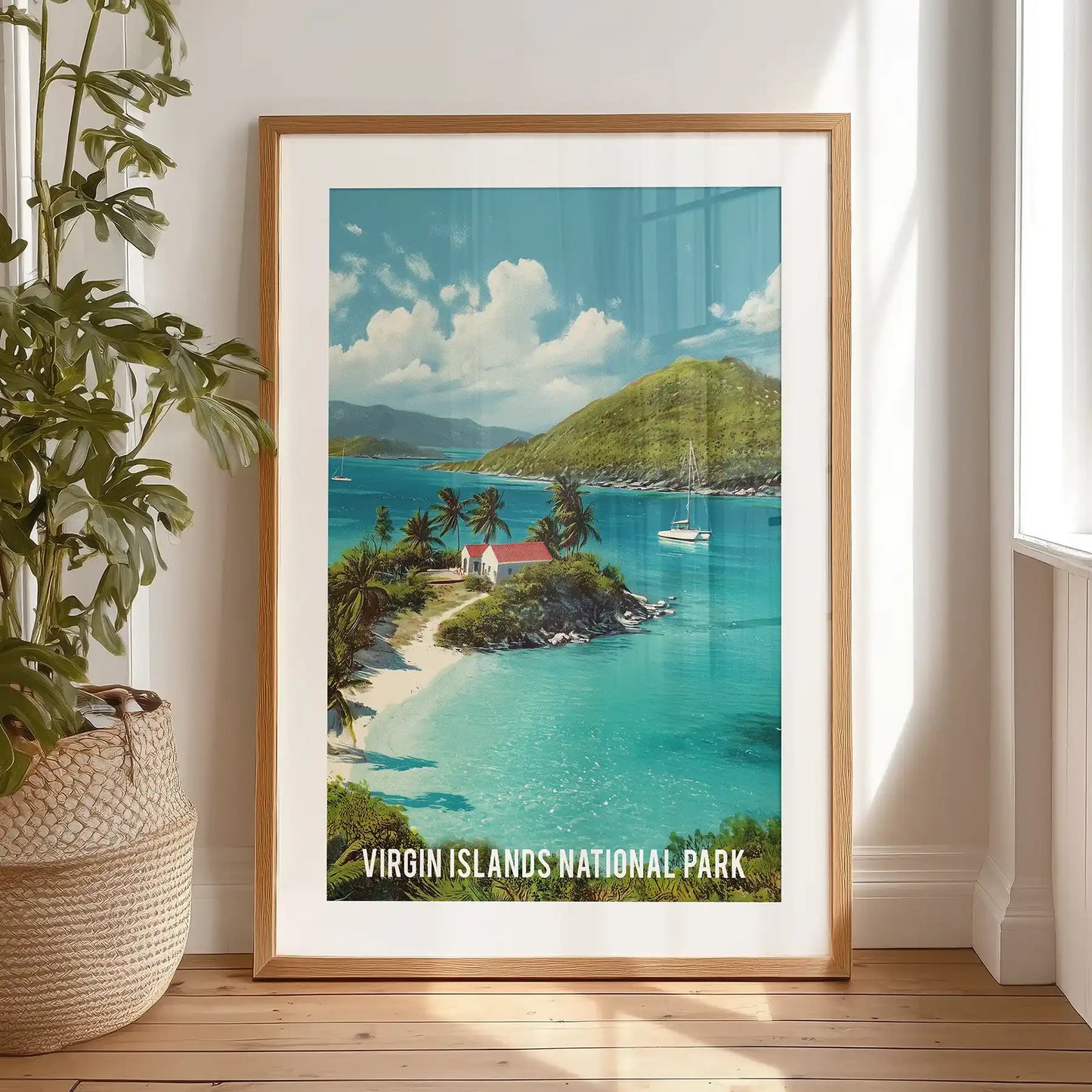 Caribbean beach with palm trees large poster print in a black frame with a wide mat is propped on the bedroom floor, vivid turquoise and sunlit sand.
