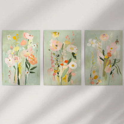 Contemporary botanical posters, a 3-piece wall art set, are unframed and arranged on a neutral wall for a clean, modern look.