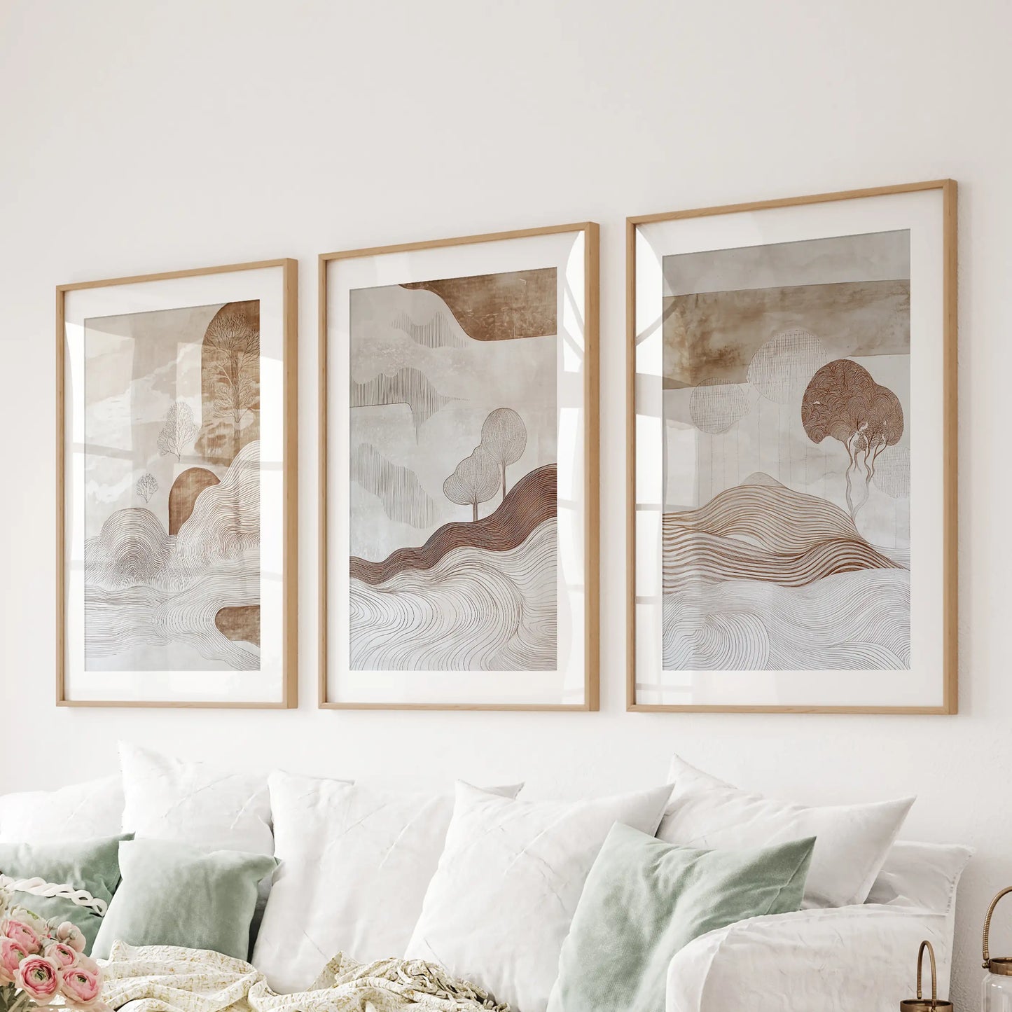 Wabi-sabi line art, matted in natural oak, forms a three-print wall set that floats above the sofa with earthy, tactile character.