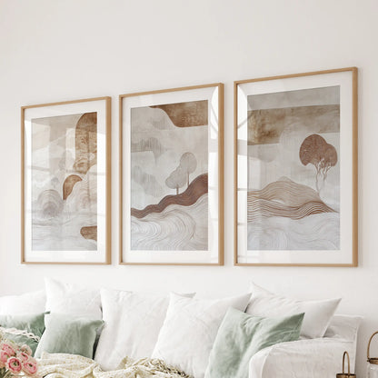 Wabi-sabi line art, matted in natural oak, forms a three-print wall set that floats above the sofa with earthy, tactile character.