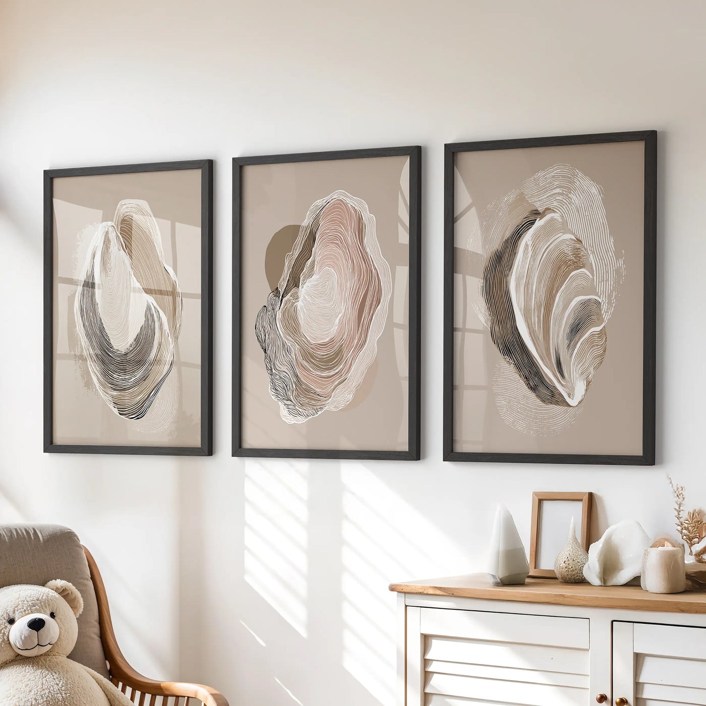 Minimalist shell illustrations, a set of three posters in black frames, hang over the playroom drawers to lend calm, tactile seaside character.