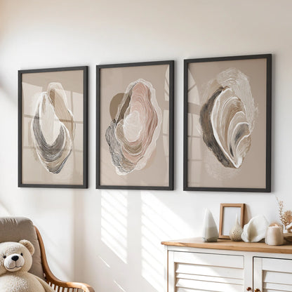 Minimalist shell illustrations, a set of three posters in black frames, hang over the playroom drawers to lend calm, tactile seaside character.
