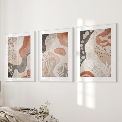 Terracotta geometric patterns, 3-piece wall decor in white matted frames, lend a calm, cohesive look to the bedroom wall.
