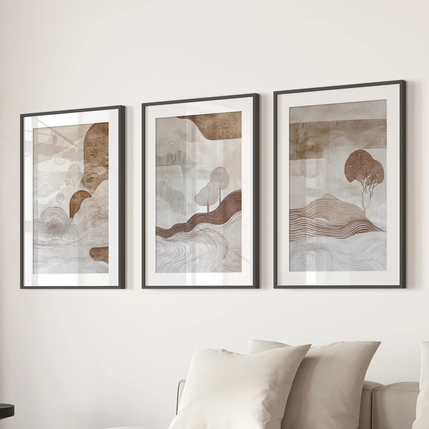 A trio of wabi-sabi line art prints, matted and framed in black, hangs above the sectional sofa for calm, contemporary lounge décor.