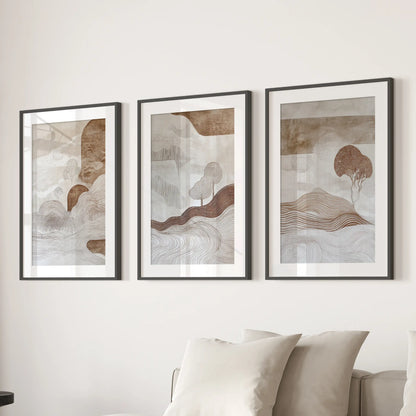 A trio of wabi-sabi line art prints, matted and framed in black, hangs above the sectional sofa for calm, contemporary lounge décor.