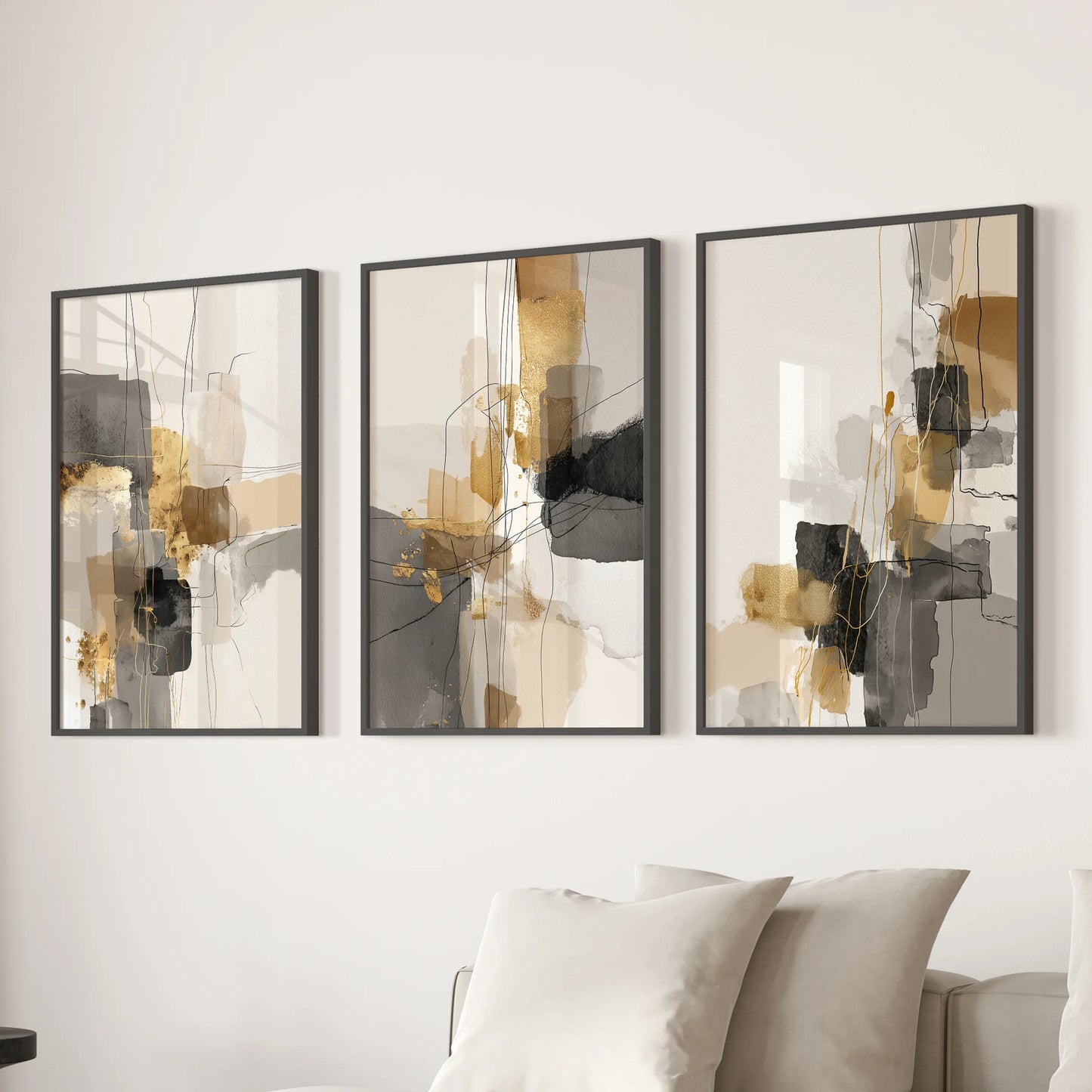 Watercolor wash abstractions, a 3-piece wall art series in sleek black frames, soften the family room scene behind the sofa with fluid, modern movement.