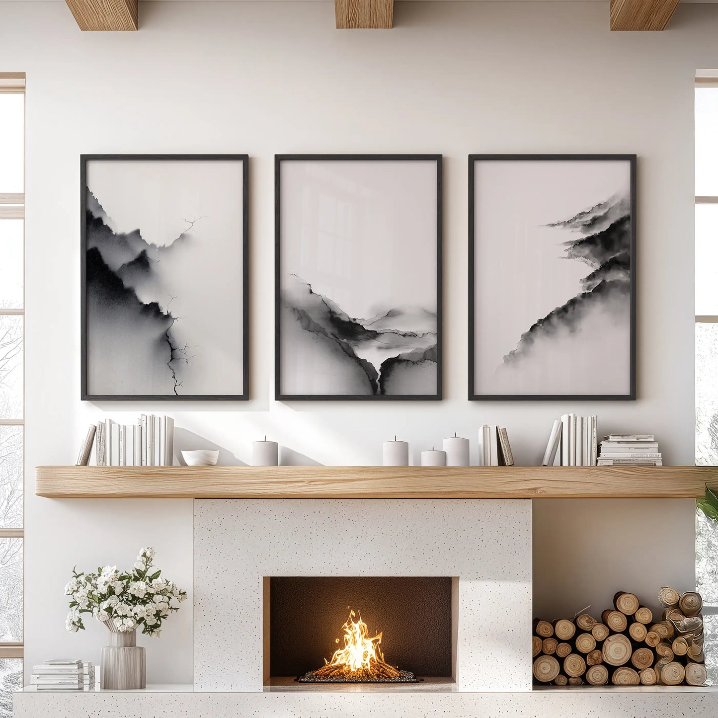 A three-piece black-framed wall art set of minimalist mountain views anchors the family room above the hearth with modern quiet balance.