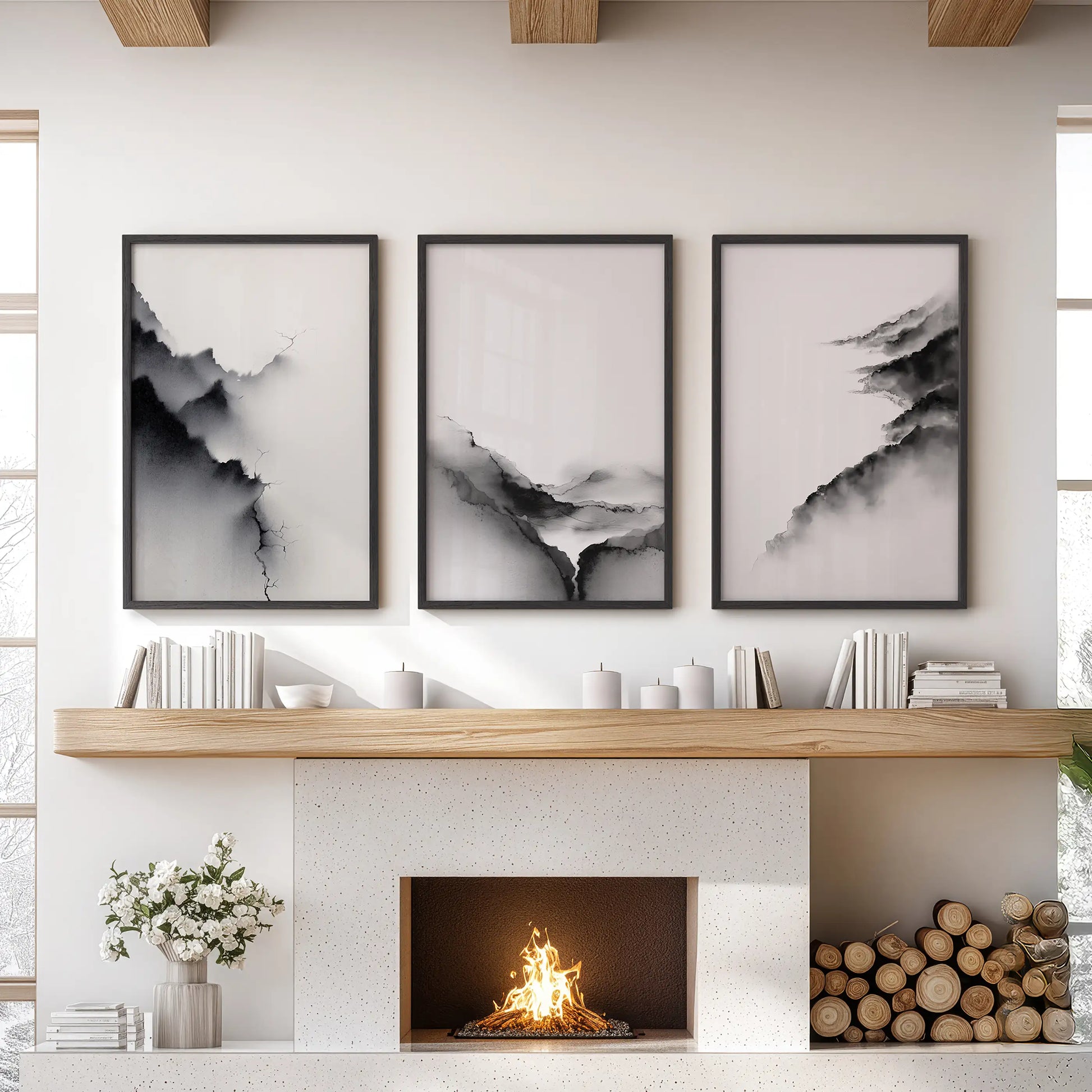 A three-piece black-framed wall art set of minimalist mountain views anchors the family room above the hearth with modern quiet balance.