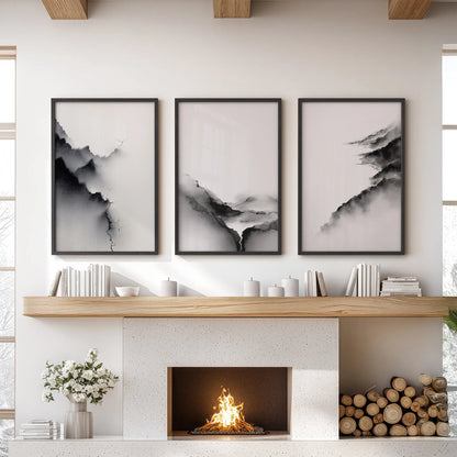 A three-piece black-framed wall art set of minimalist mountain views anchors the family room above the hearth with modern quiet balance.