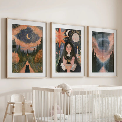 A set of three gothic nature wall art pieces in matted oak frames hangs above the crib, adding warm woodland tones and a gentle celestial hush.