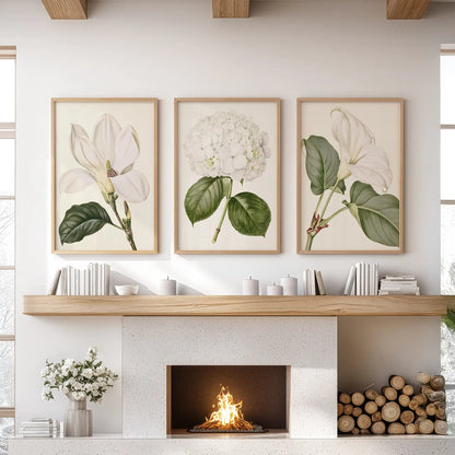 White flower and greenery prints in oak frames, a set of three above a fireplace.