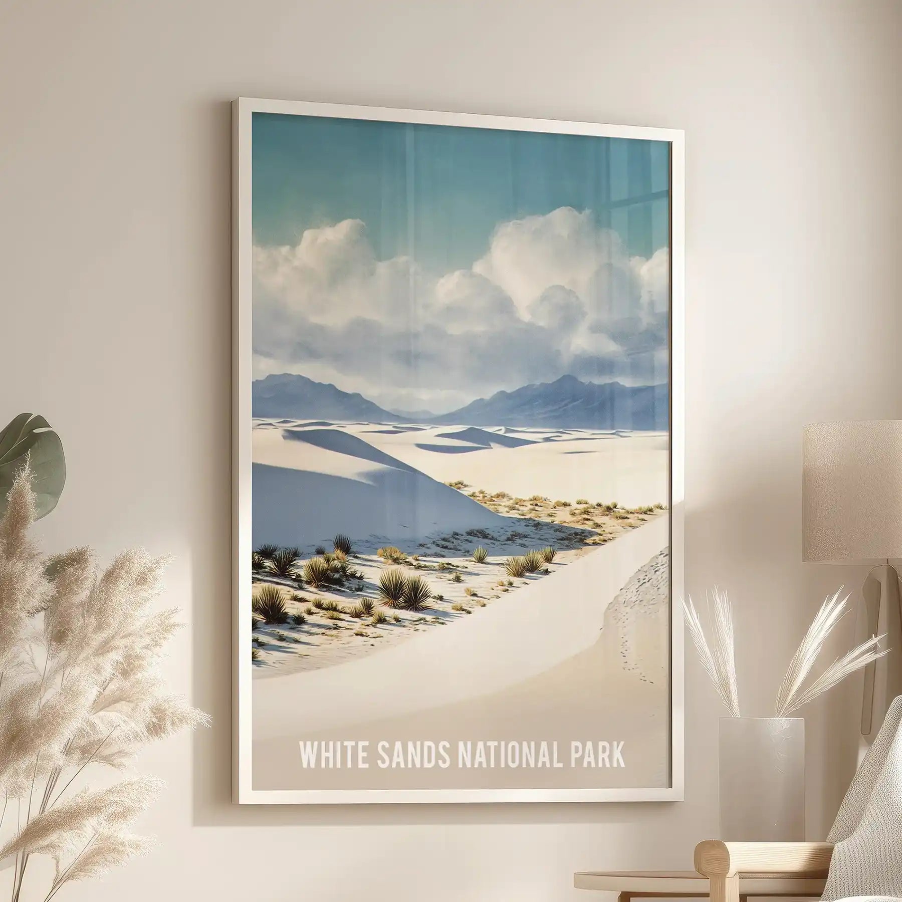 White-framed art print of a minimalist desert panorama leans near an accent chair, creating a calm point of focus in the sitting room.