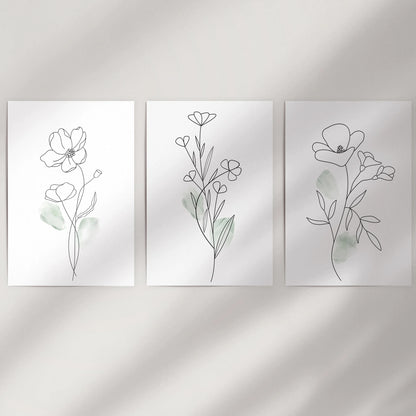 Unframed black line wildflower prints come rolled as a three-piece set, ready to fill an empty wall with clean, organic movement.