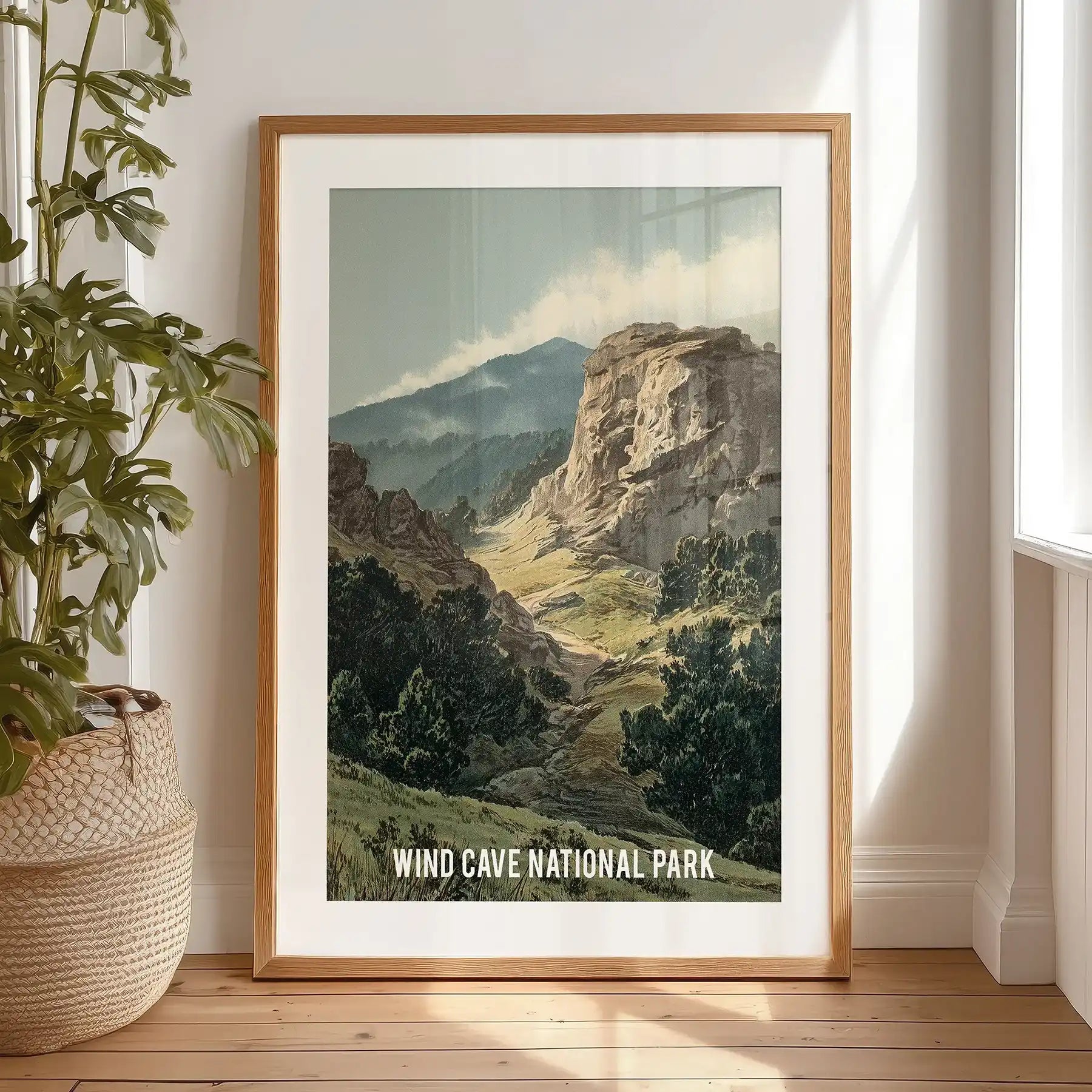 Wind Cave National Park landscape large wall poster, a black framed print with mat, rests by the bedroom window for an easy, gallery-style display.