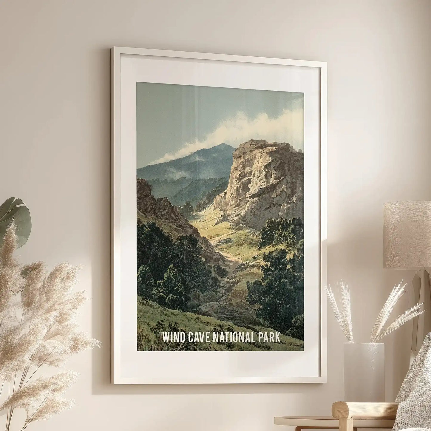 An individual art print of a vintage park scene, framed in white with matting, hangs over the living-room lounge chair for a timeless outdoor spirit.