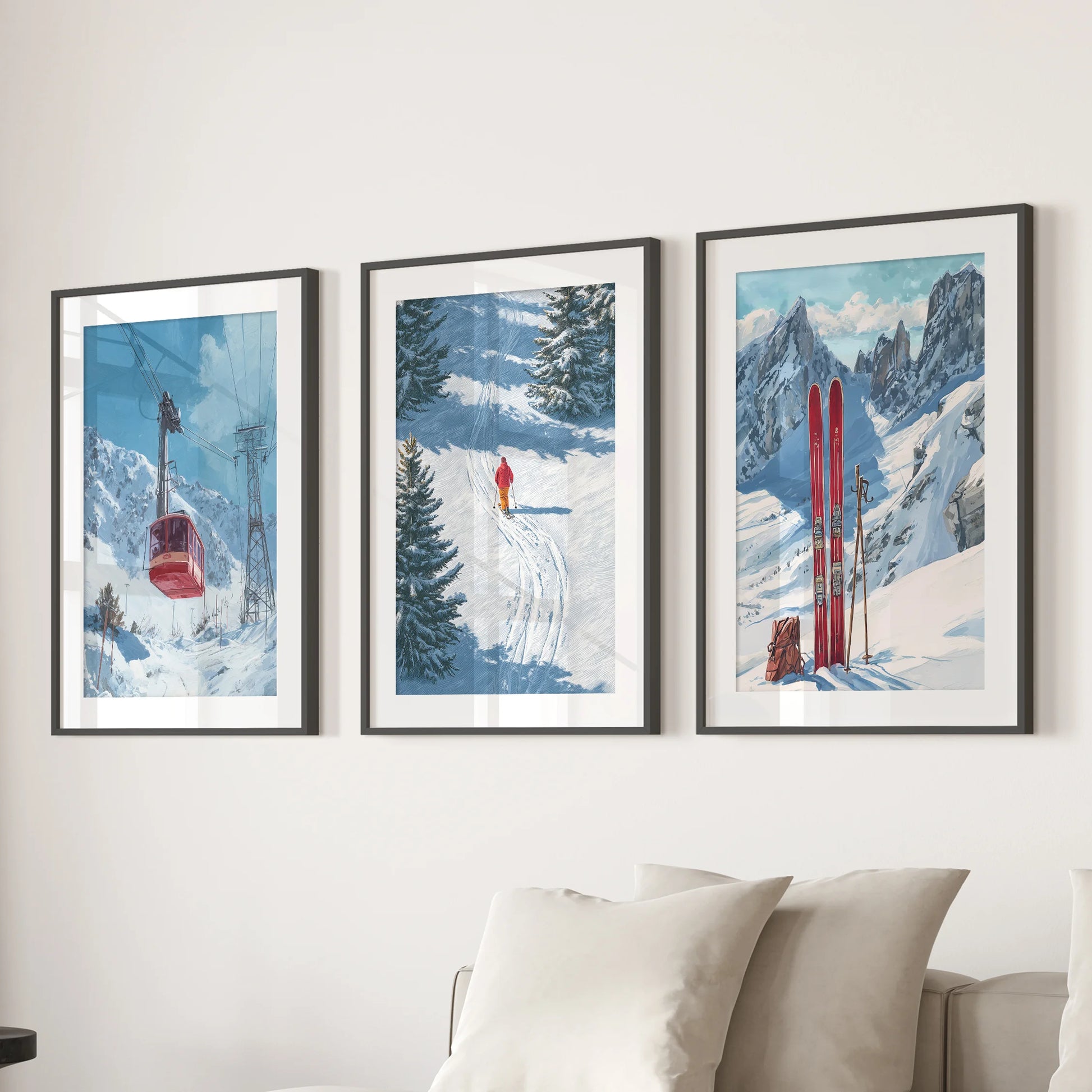 Three vintage ski lift prints in black mat frames create wall decor above a living room sofa, giving it a crisp, retro alpine character.