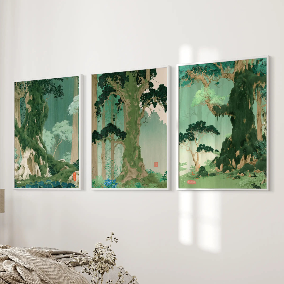 A three-print woodblock-style landscape wall art set in white frames hangs beside the bed in a bedroom.