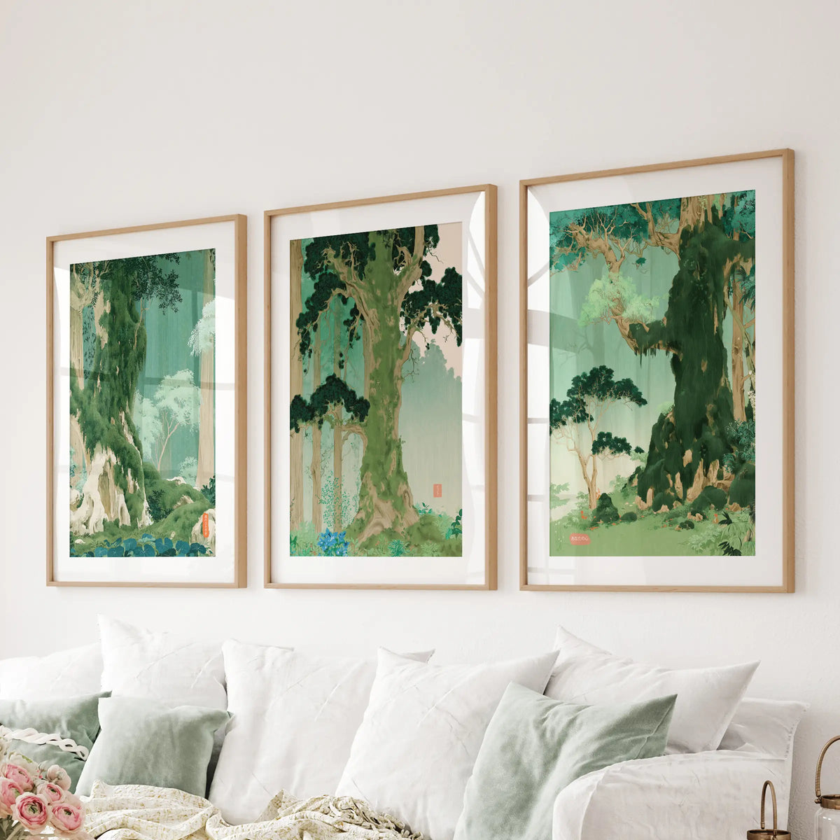 Woodblock-style landscape wall art, a set of three posters in matted wood frames, hangs behind the sofa in the lounge.