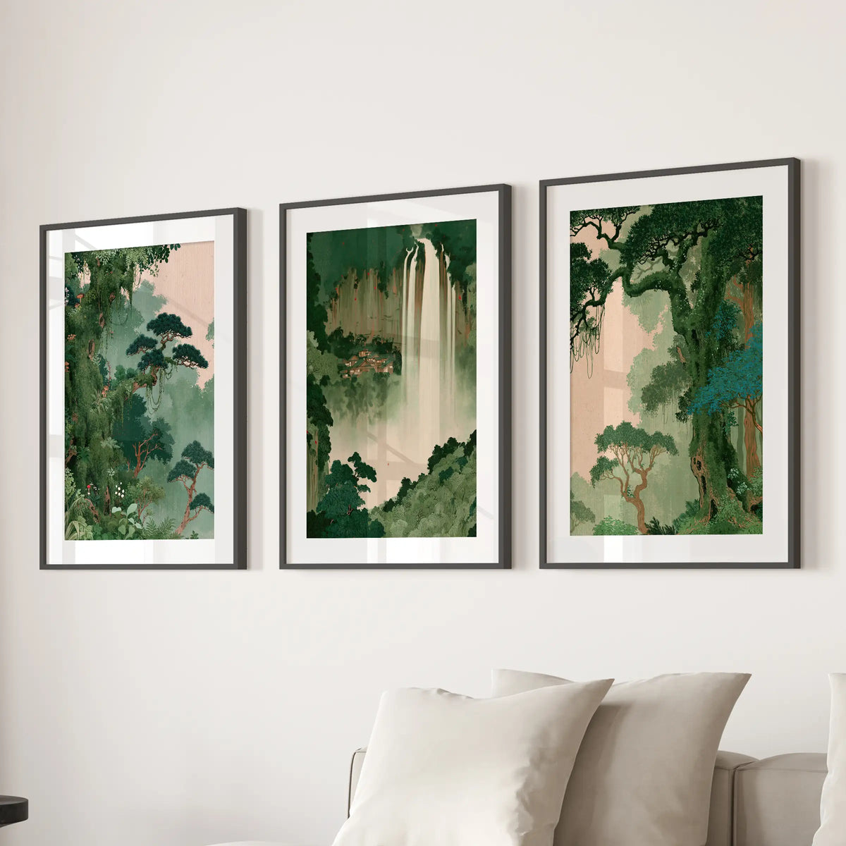 Woodland botanical wall art trio in black matted frames, arranged behind a sofa in a lounge.