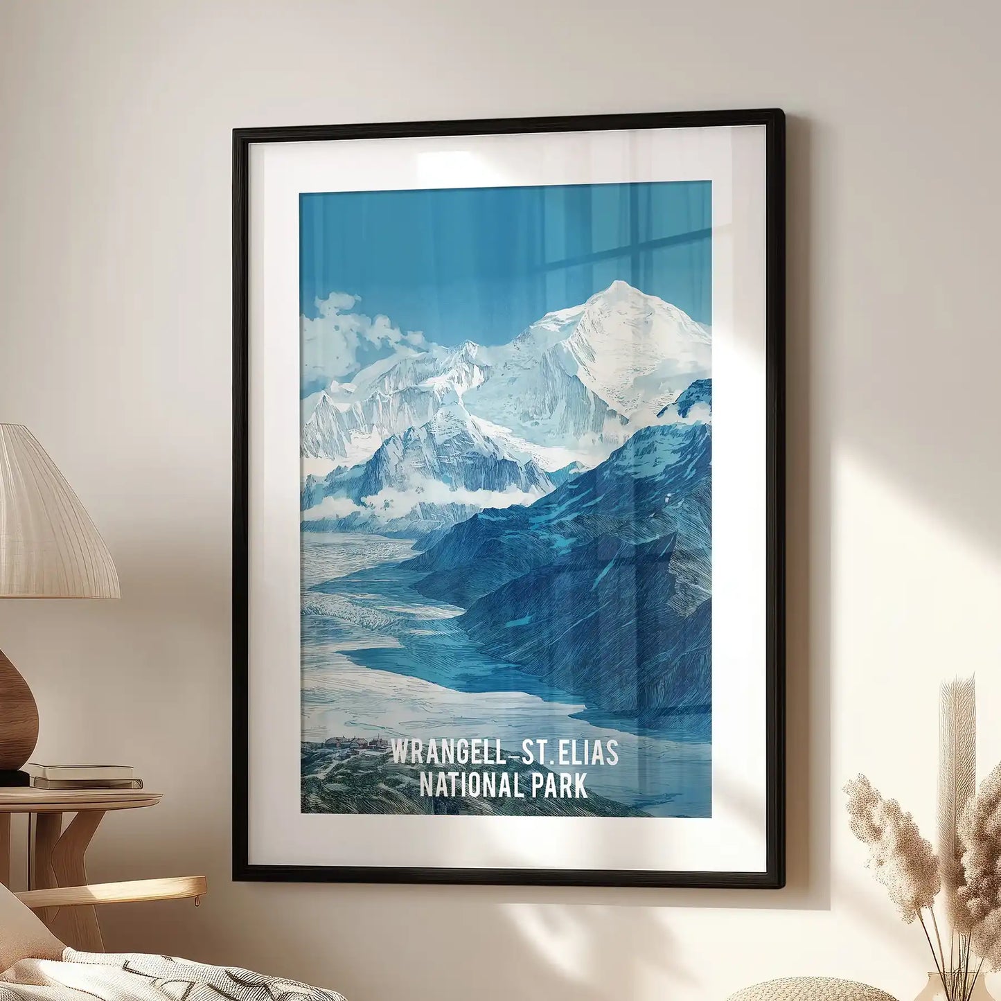 This large glacier wilderness poster in a black frame with a wide mat sits near a reading chair, giving the room a crisp, adventurous tone.