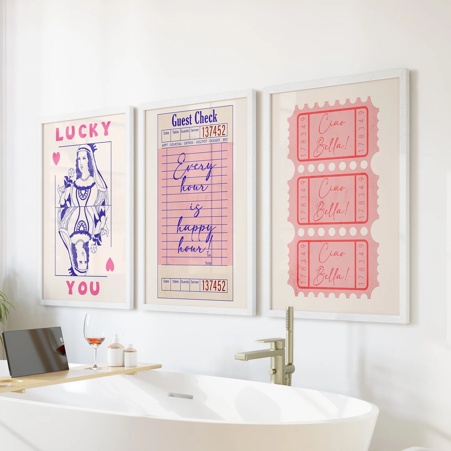 Pink guest check prints, a wall art trio, arrive as white-framed pieces made to perch above the bath and add soft, playful color to the bathroom.