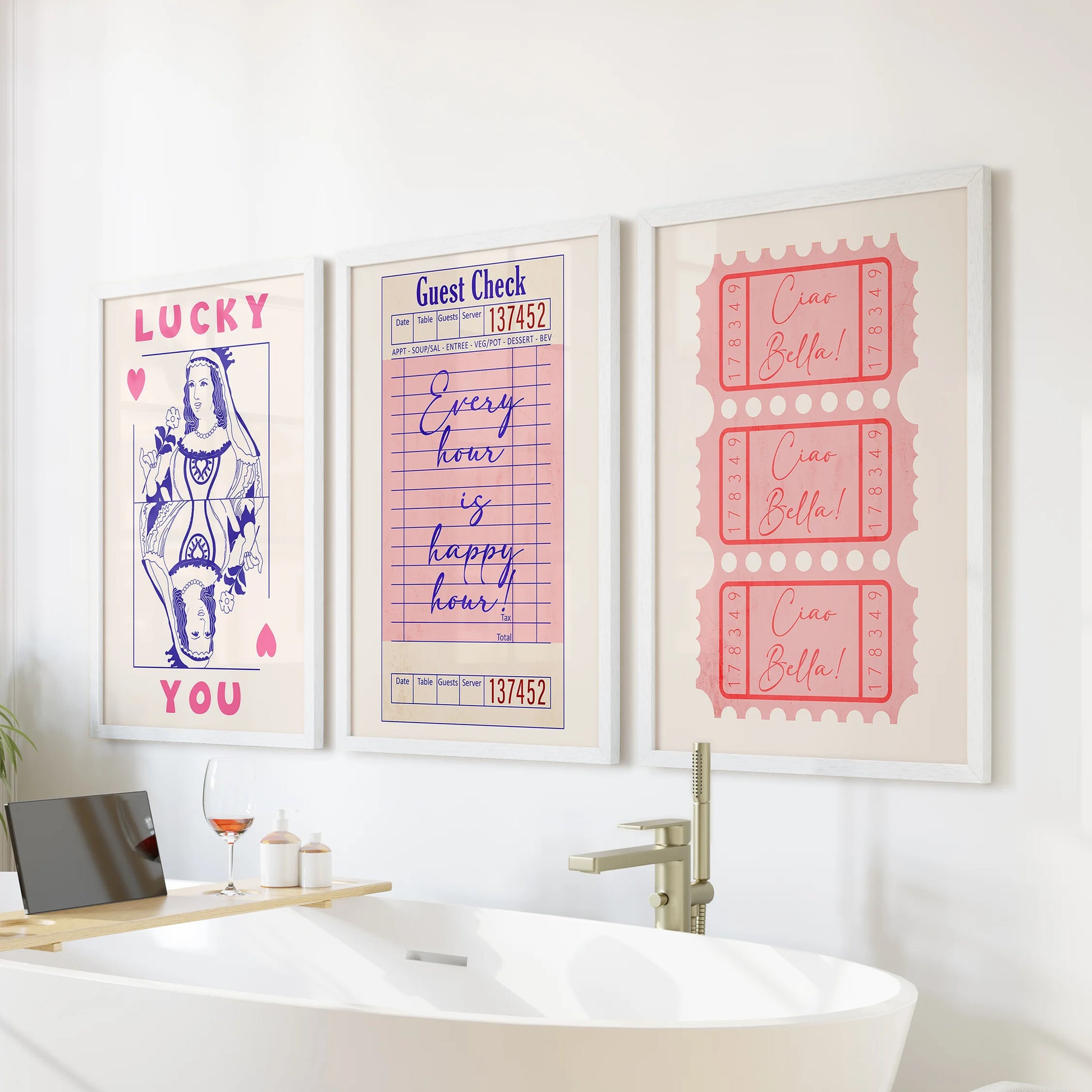 Pink guest check prints, a wall art trio, arrive as white-framed pieces made to perch above the bath and add soft, playful color to the bathroom.