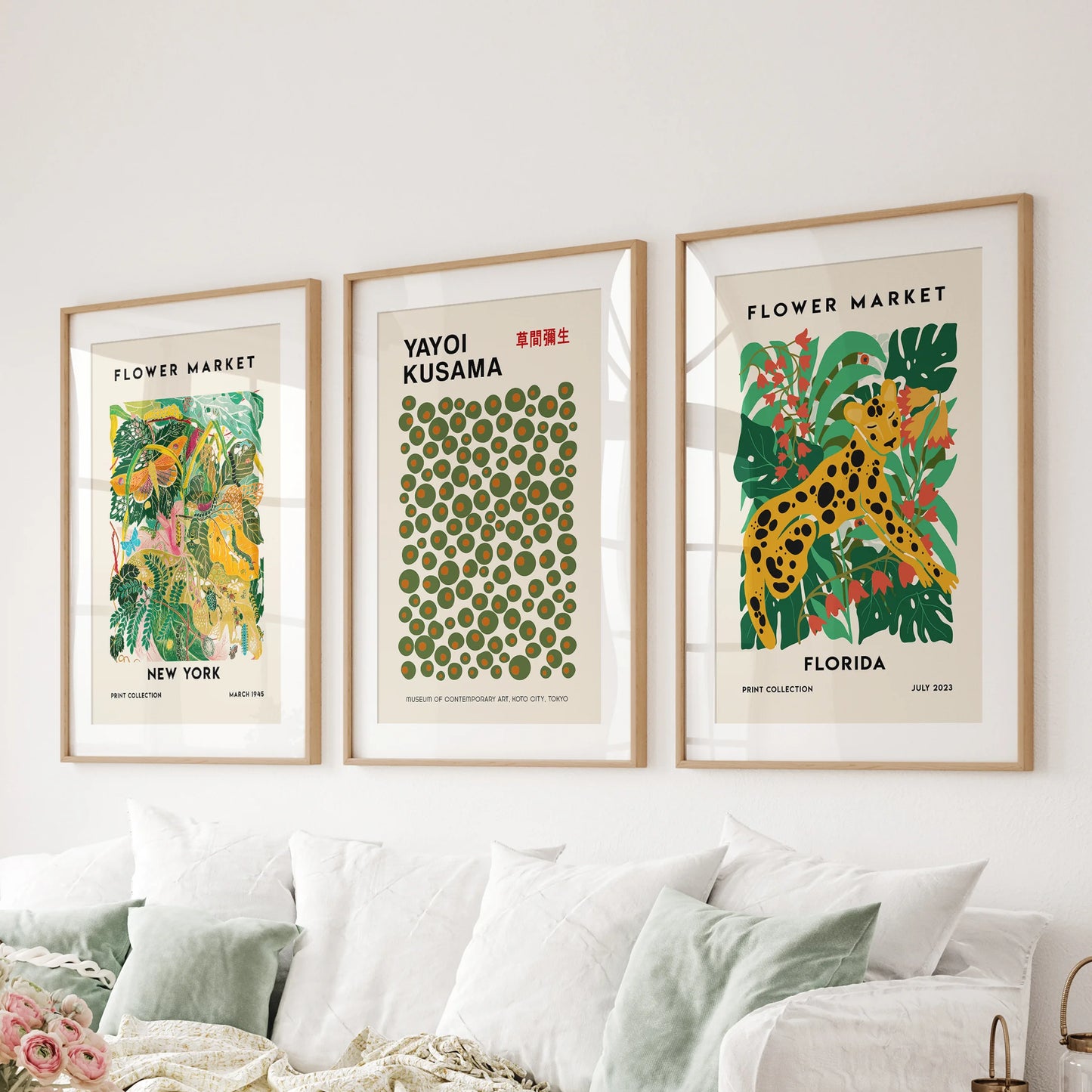 Kusama-inspired dotted wall art in three thin wood-matted frames brings crisp, joyful rhythm to the lounge behind the couch.