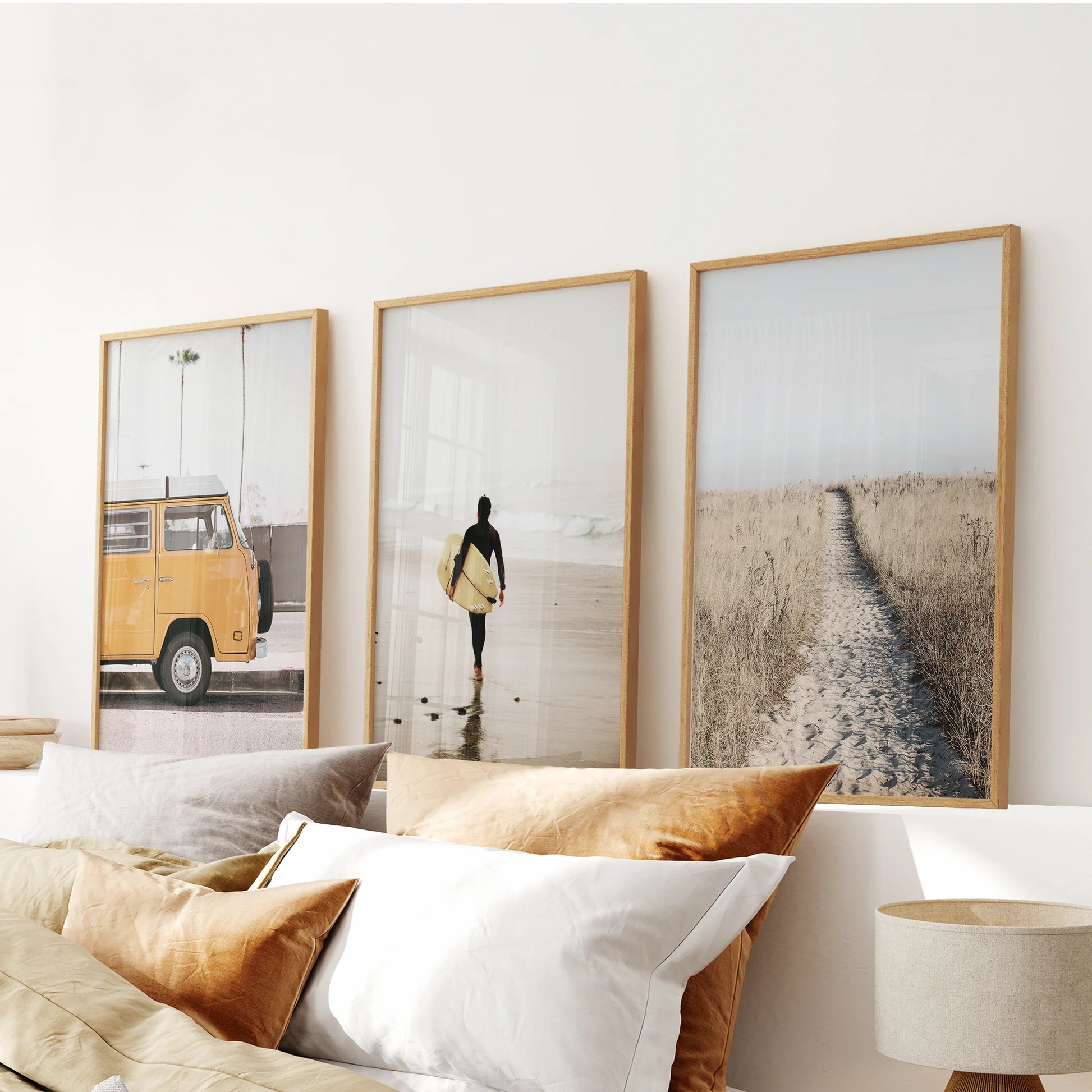 Set of three yellow beach van pictures in oak frames hangs above the bed, filling the bedroom with sun-washed coastal nostalgia.