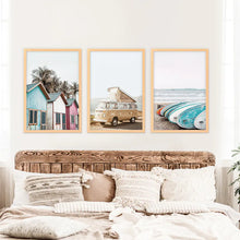 Load image into Gallery viewer, Coastal Set of 3 Prints in Beige, Blue and Pink Tones. Ocean Beach with Surfboards, Cabins, Yellow Travel Van. Wood Frames
