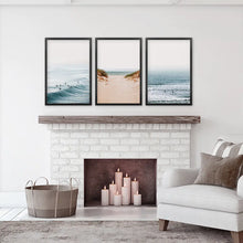 Load image into Gallery viewer, Beige Sandy Beach, Blue Ocean Waves, Surfers. Set of 3 Prints. Black Frames
